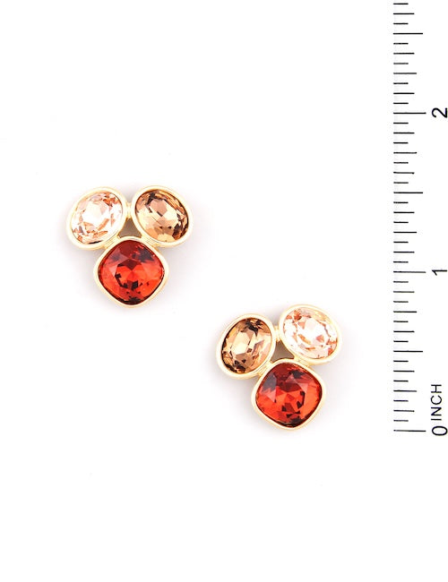 Meghan Brown VIV MT earrings with red gold and champagne colored triple stone stud earrings. with a ruler
