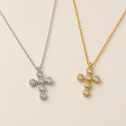 Meghan Browne ABI-SV and ABI-GD  necklaces both have a cross pendant with clear diamond like crystals in the shape of a cross one in gold and the other silver