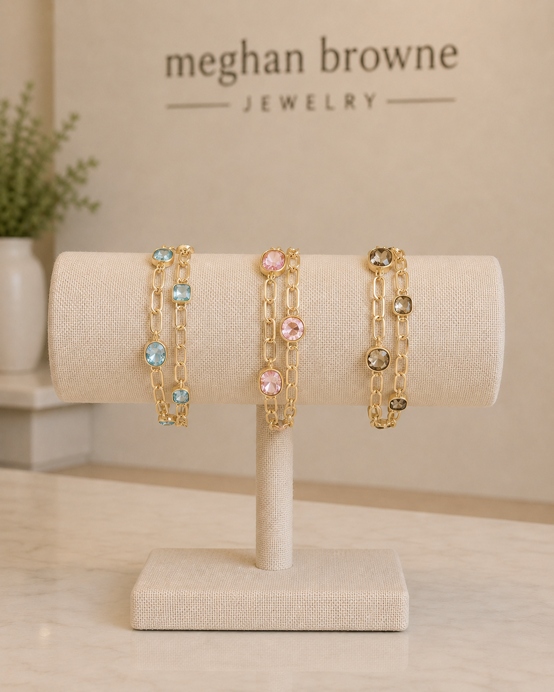 Meghan Browne Goldie bracelets each with a double gold chain link with colored gemstones 