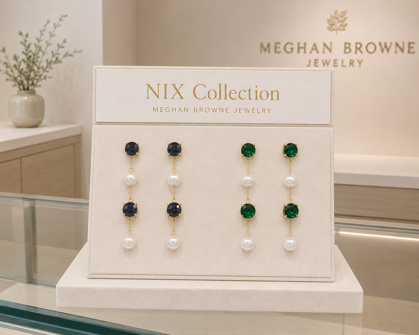 meghan browne nix earrings with  2 inch gold chain dangles alternating stones and pearls with black and emerald crystals
