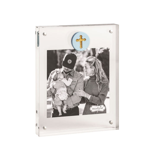   Clear acrylic picture frame by mudpie with a blue circle toward the top of the picture enclosing a gold cross. 