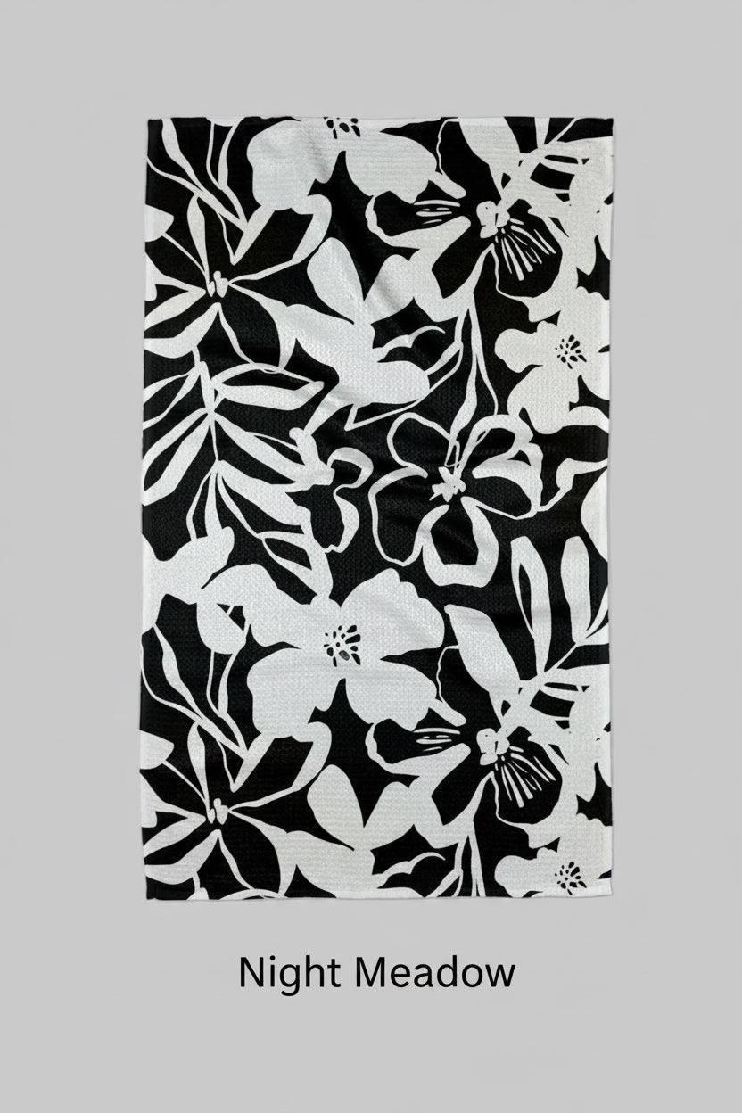 Black and white floral patterned Geometry night meadow tea towel on a white background