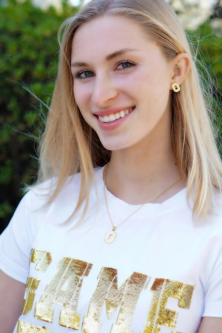 Girl wearing Gold plated signature  stud earrings and necklace to show her support for the ohio state buckeyes with a white and gold game day tshirt