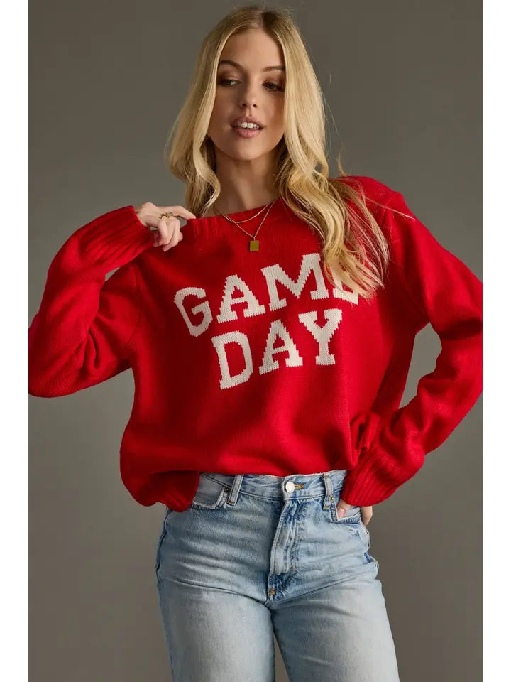 Person wearing a red 'GAME DAY' sweater by Panache  against a gray background