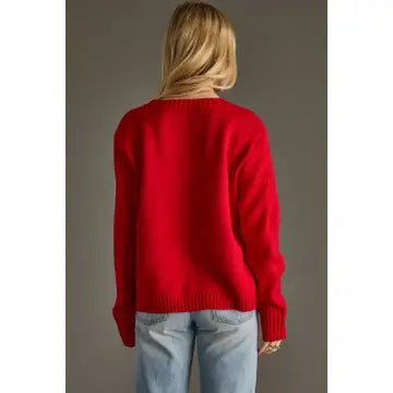 The back of a Person wearing a red Game DAy Panache sweater and light blue jeans against a gray background