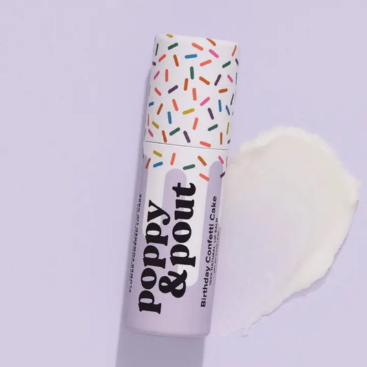 Lip balm with 'Poppy & Pout' branding and purple birthday cake confetti design on a light gray background