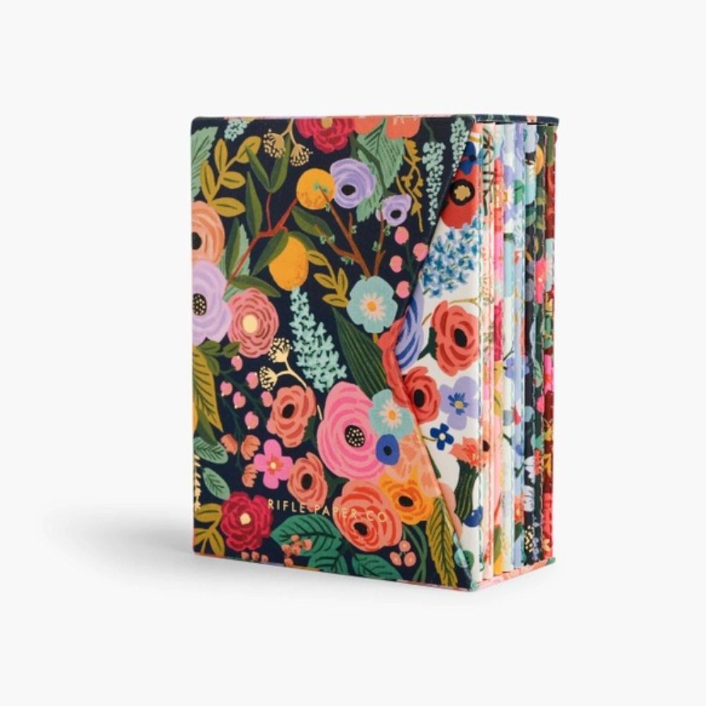 A boxed set of 8 pocket-sized notebooks with a Garden Party floral design on the covers.