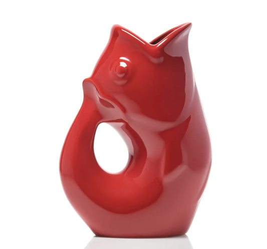 Red ceramic GurglePot pitcher shaped like a fish featuring a gurgling noise