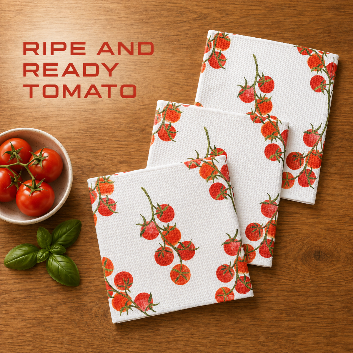 Geometry ripe and ready tomoato dishcloth set with Three white kitchen towels with a red cherry tomato vine pattern are arranged on a wooden table next to a bowl of fresh tomatoes and basil leaves. Text in the upper left reads 'RIPE AND READY TOMATO'.  The Little Exchange SKU 148303