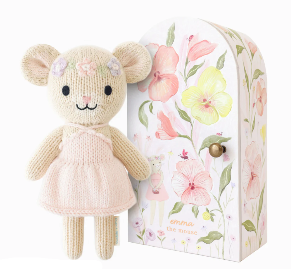 Knitted mouse toy in a pink dress with a floral headband beside a floral printed box