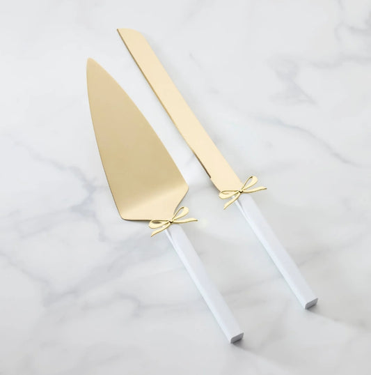 Gold cake server and knife with a white handle and gold bow