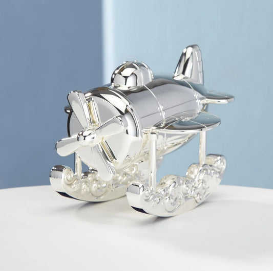 Lenox Silver airplane figurine bank on a white surface with a light blue background