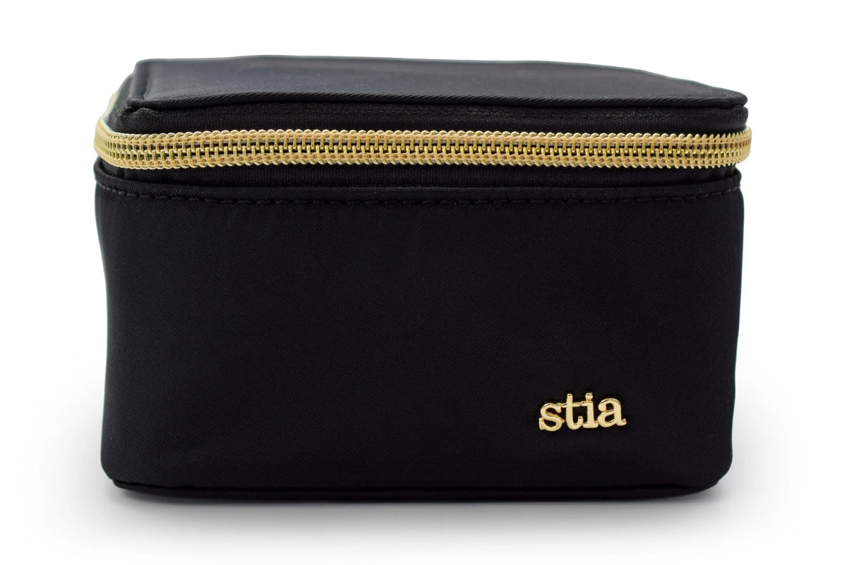 Black travel jewelry case with gold zipper and 'stia' branding on a white background