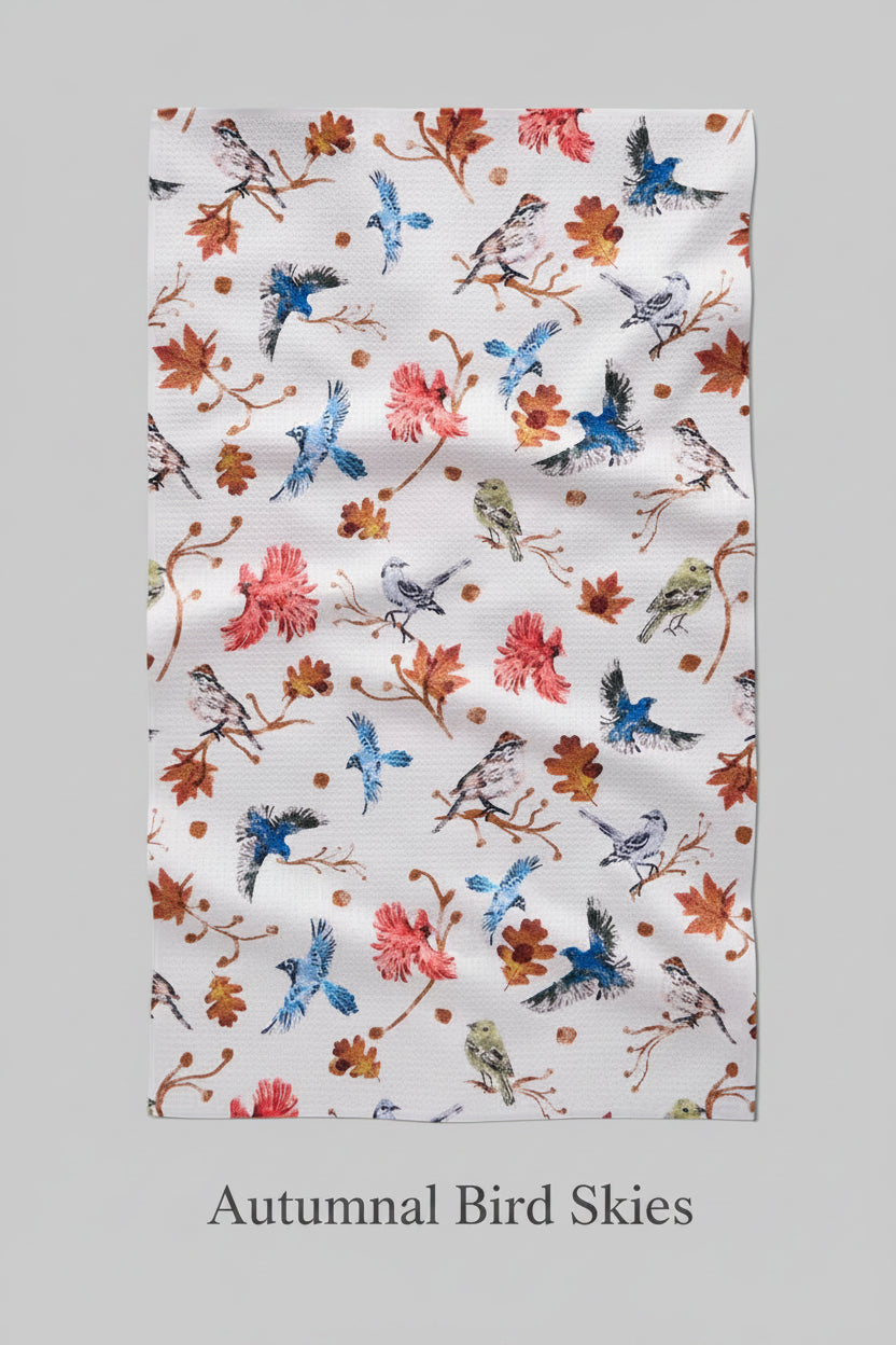 Floral and bird patterned geometry autumnal bird skies tea towel on a white background