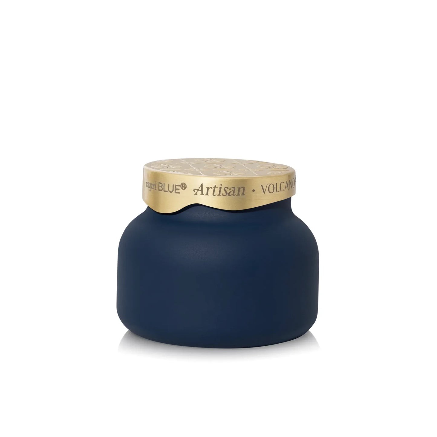 A New Blue Artisan Volcan candle in a rounded matte navy blue jar with a textured gold lid, shown on a clean white background.