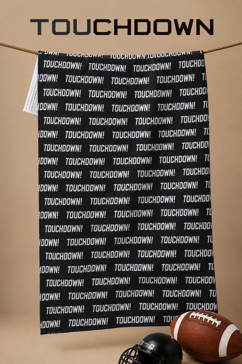 Geometry Touchdown Recreations Tea Towel is a A black towel repeatedly with the word 'TOUCHDOWN!' in white, hanging from a rope against a tan background. The word 'TOUCHDOWN' appears in large black letters at the top, and a football and helmet are partially visible at the bottom.  The Little Exchange SKU 116518