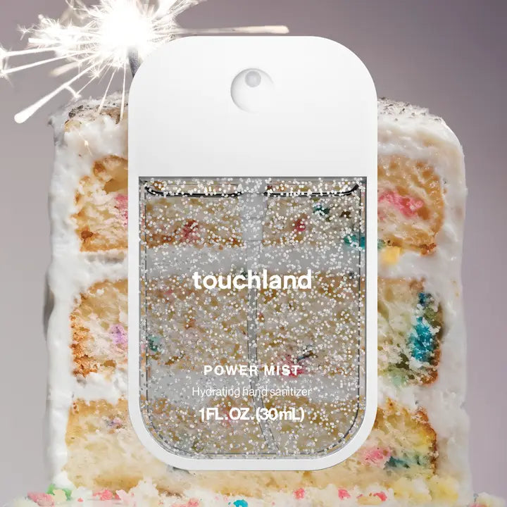 Touchland power mist sanitizer in front of a piece of Confetti cake