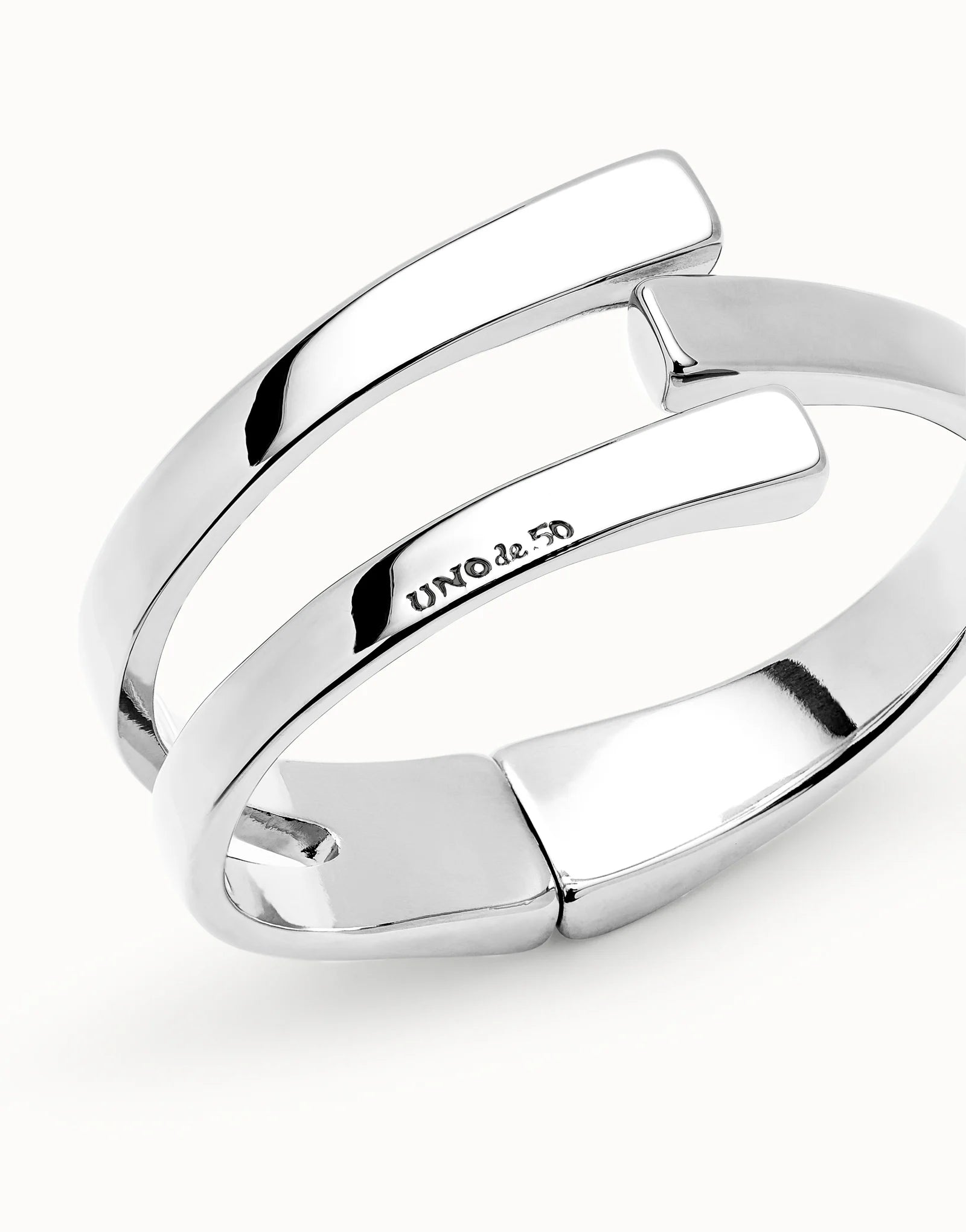 Close up of UNOde50 Ser Original Silver Bangle Bracelet with the UNO de 50 logo