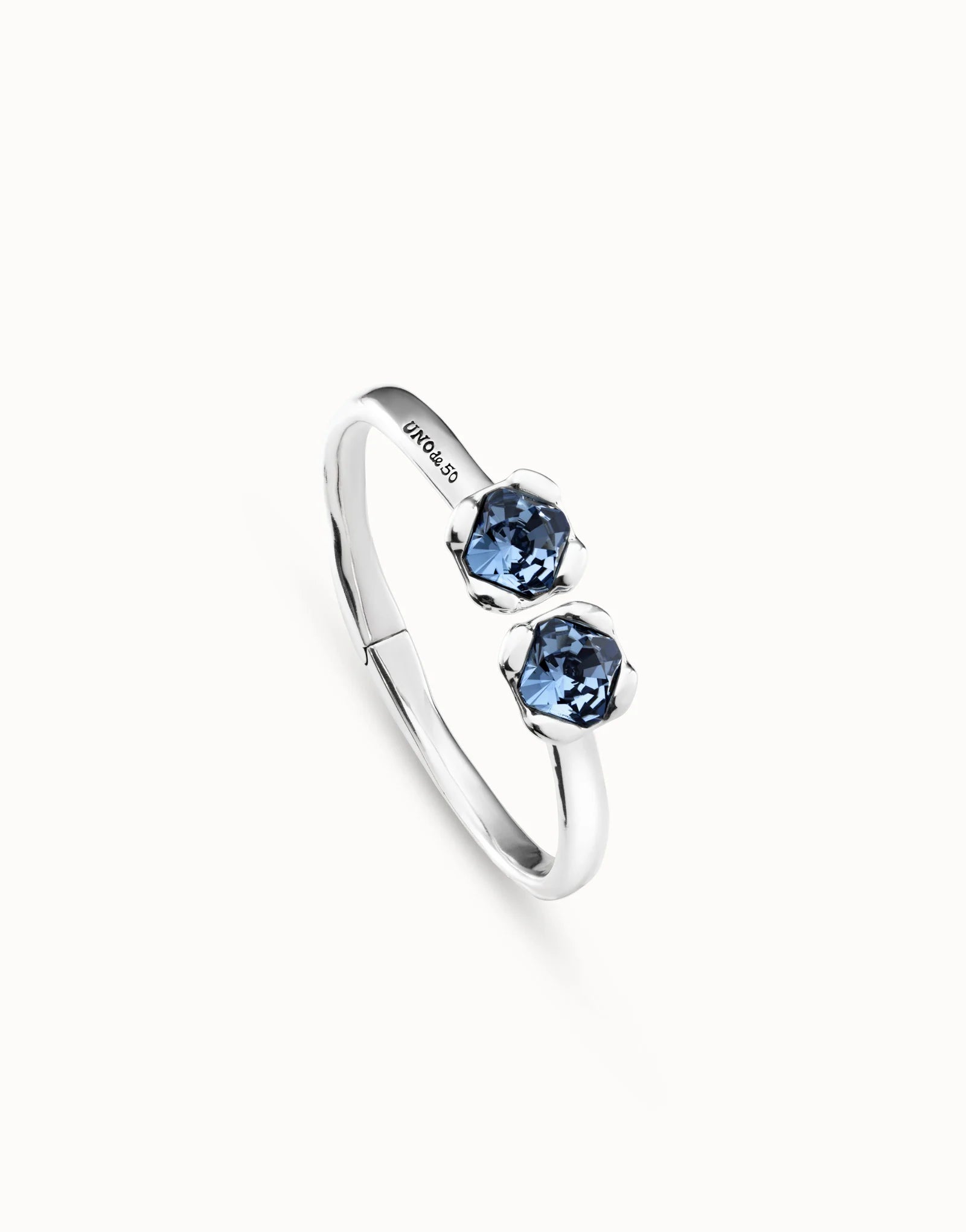 UNOde50 Aura Blue Silver Bangle Bracelet showing the detail of the two two Blue Crystals and the UNOde50 logo