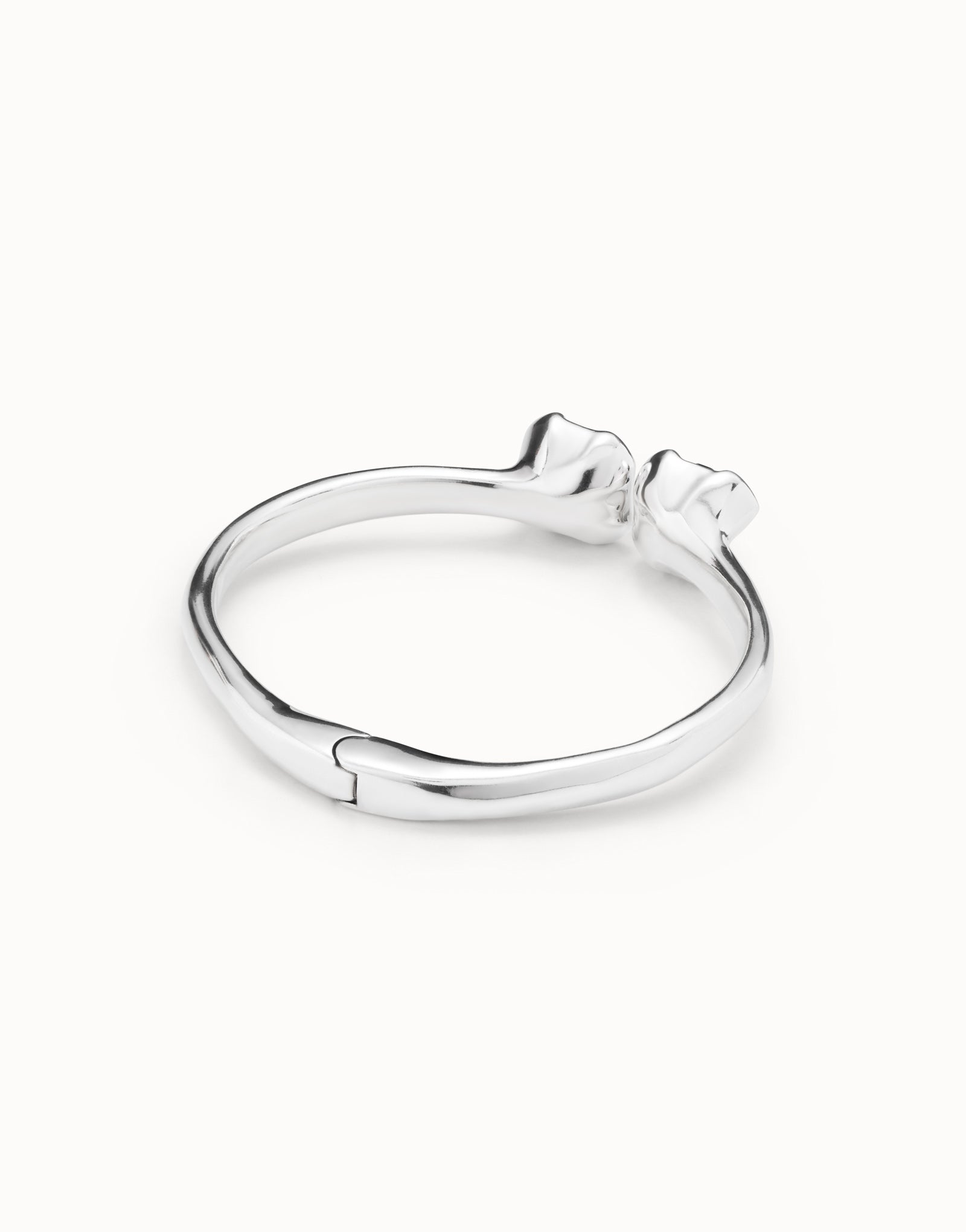 Back or inside view of the UNOde50 Aura Blue Silver Bangle Bracelet with two Blue Crystals showing where the cuff bends.