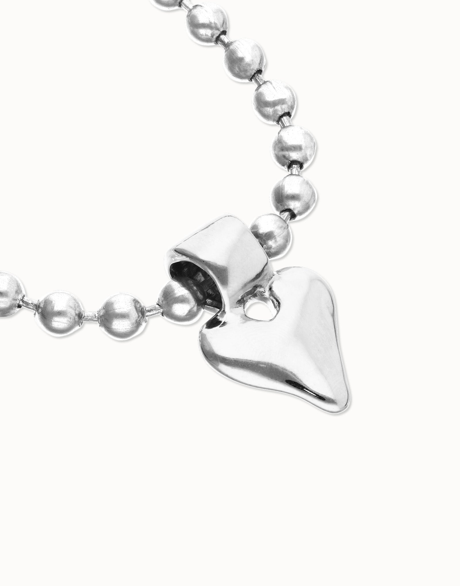 Silver beaded UNOde50 Beat Silver Bracelet with a heart-shaped pendant on a white background