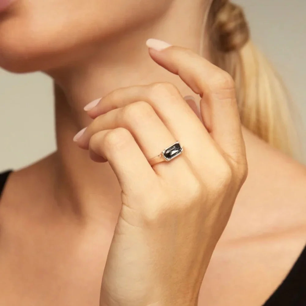 Woman wearing an UNOde50 Cobra Silver Ring with Gray Elongated Crystal
