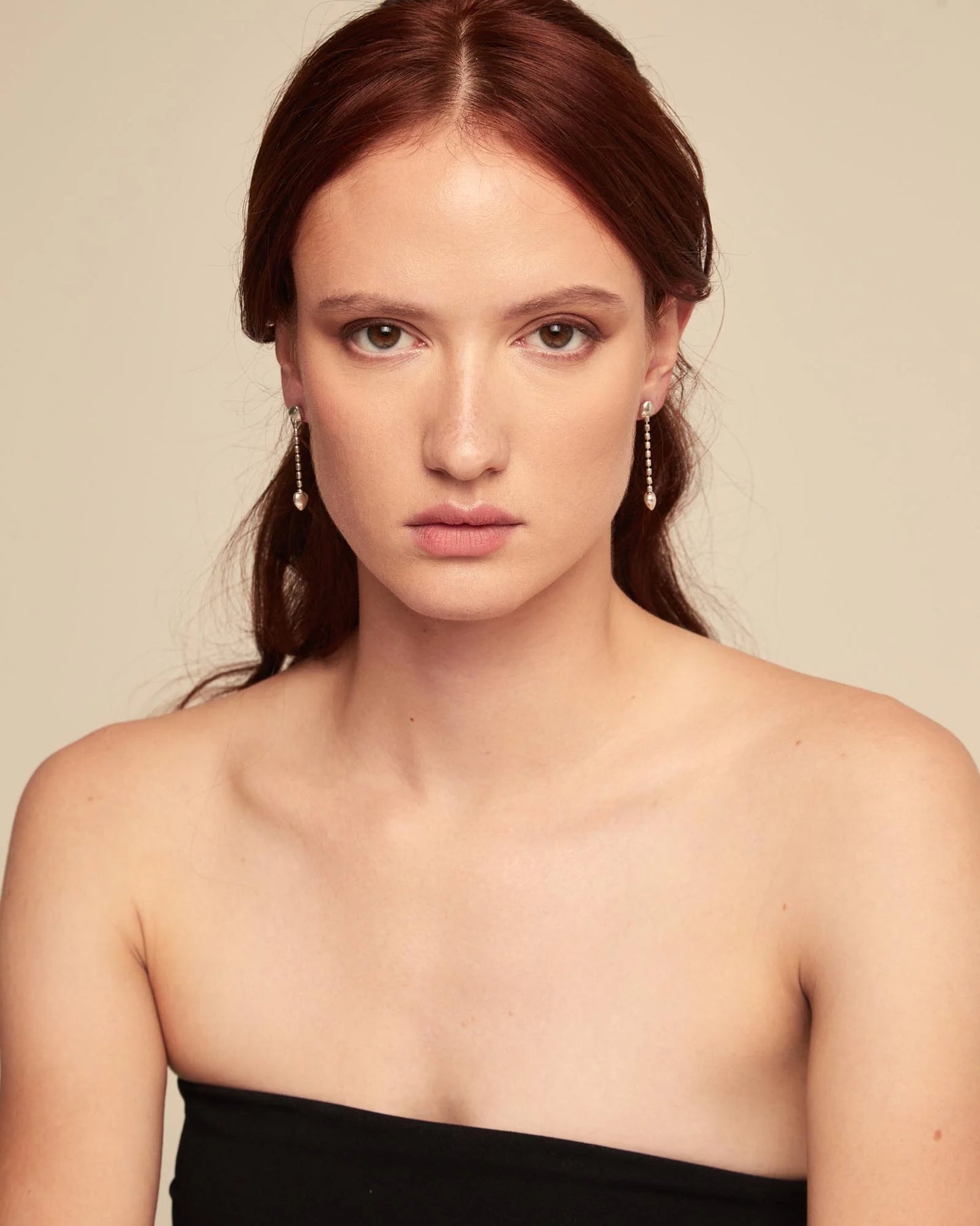 Woman wearing UNOde50 Cupido Silver Drop Earrings with a Small Heart