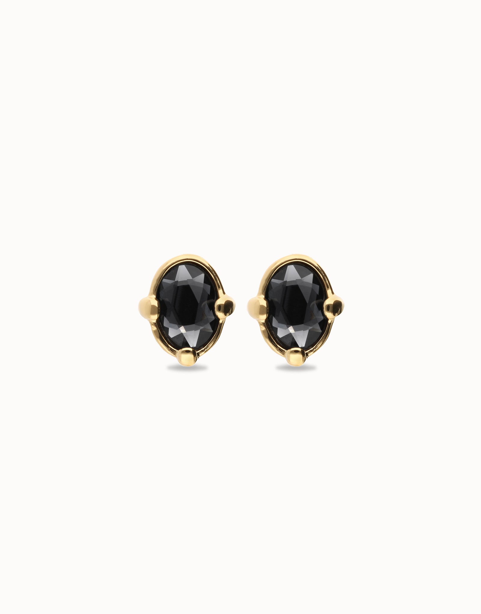 Front view of UNOde50 Ser Deslumbrante Gold Stud Earrings with Black Oval Crystal on white background