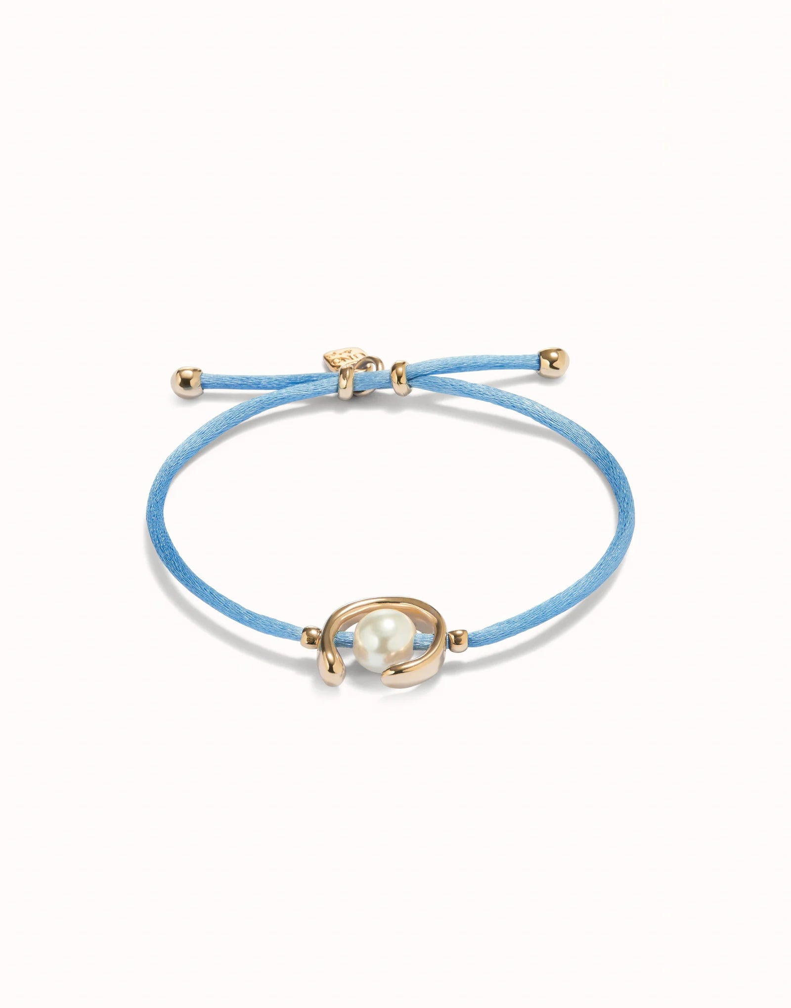 unode50 Blue bracelet with gold clasp and pearl-like bead on a white background
