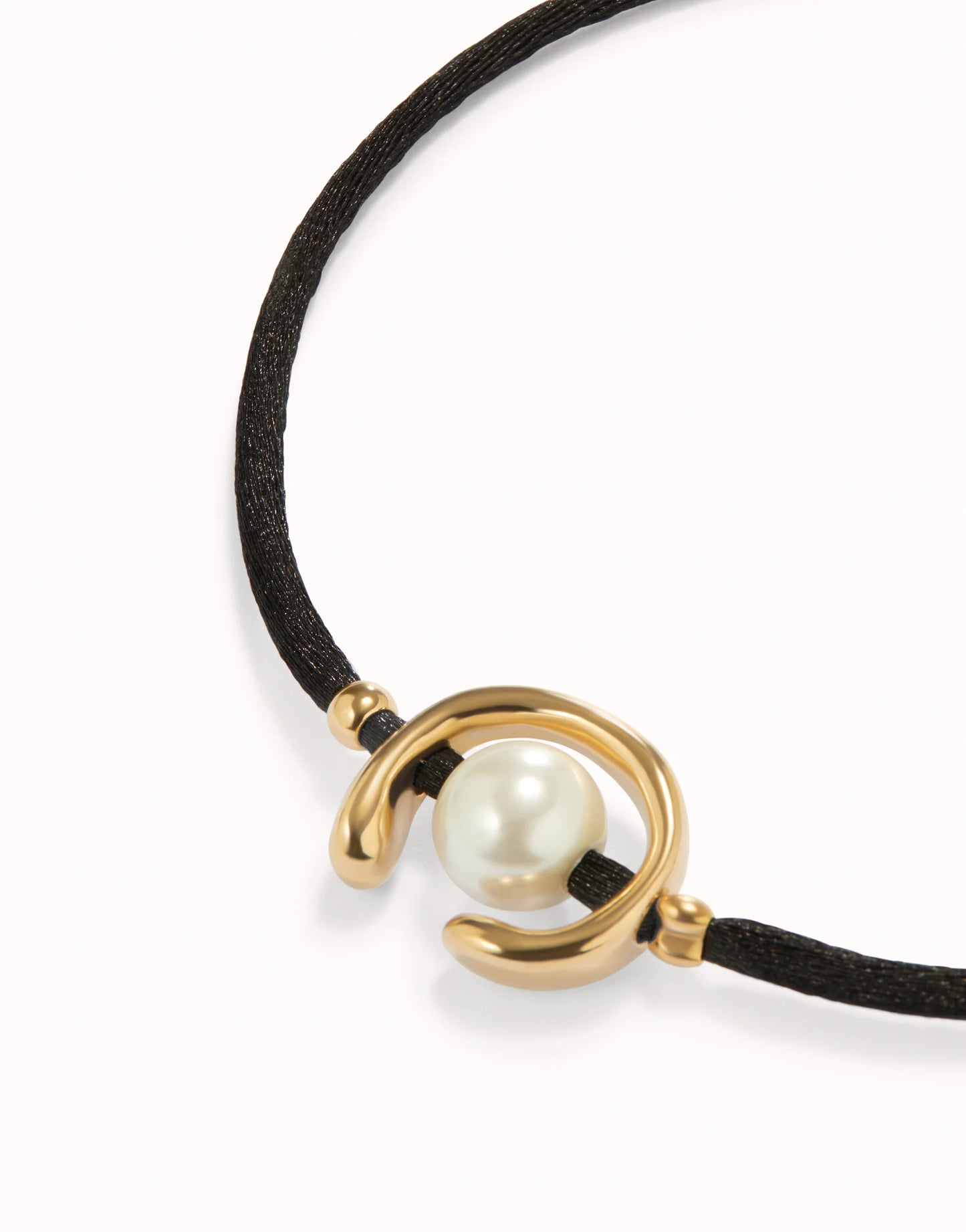 Unode50 Bracelet with gold design and pearl on a black cord against a white background