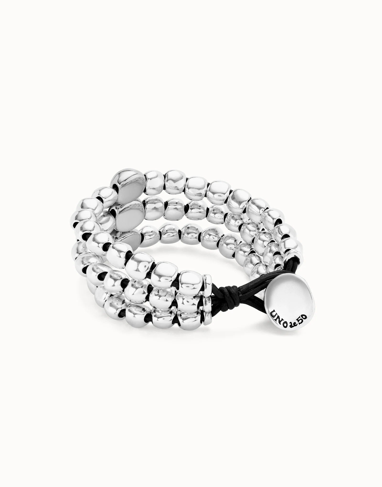 Silver 3 strand Ser Intrepida UNOde50 beaded bracelet with a black cord on a white background