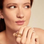 Woman wearing UNOde50 Serotonin Gold Ring