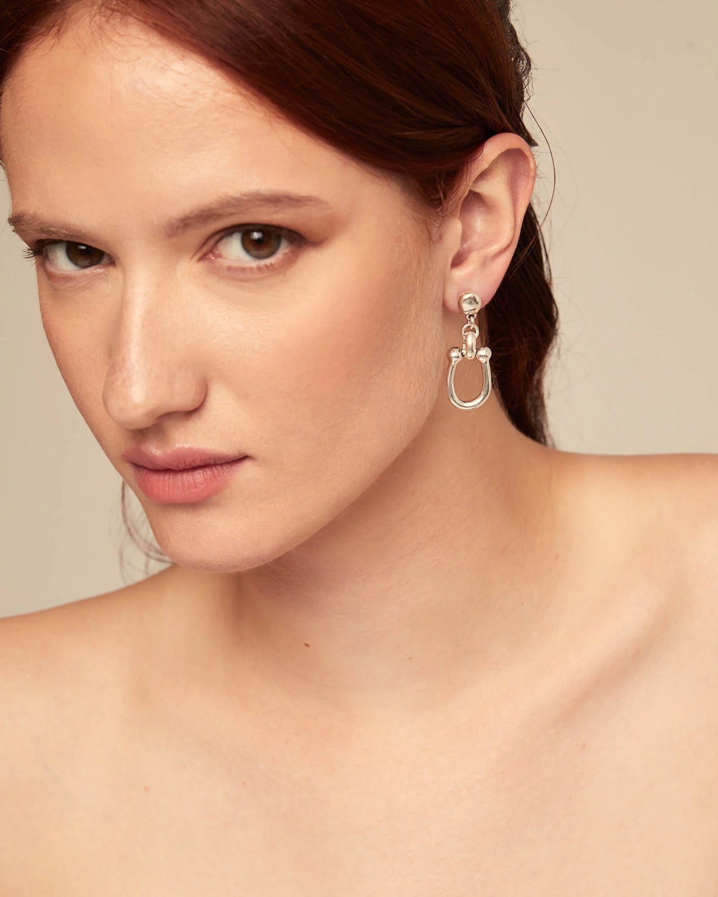 Woman wearing UNOde50 Serotonin Silver Drop Earrings with Medium Sized Link