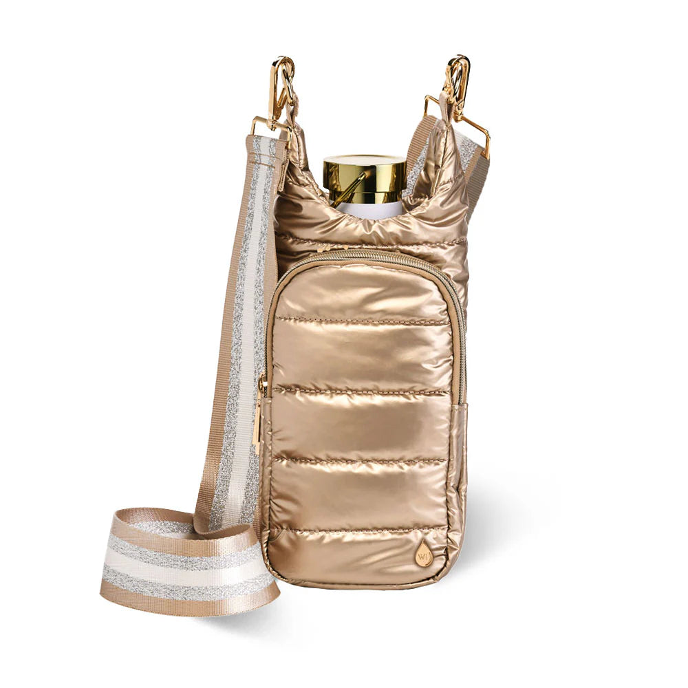 gold crossbody bag that holds a water bottle with zippered compartments