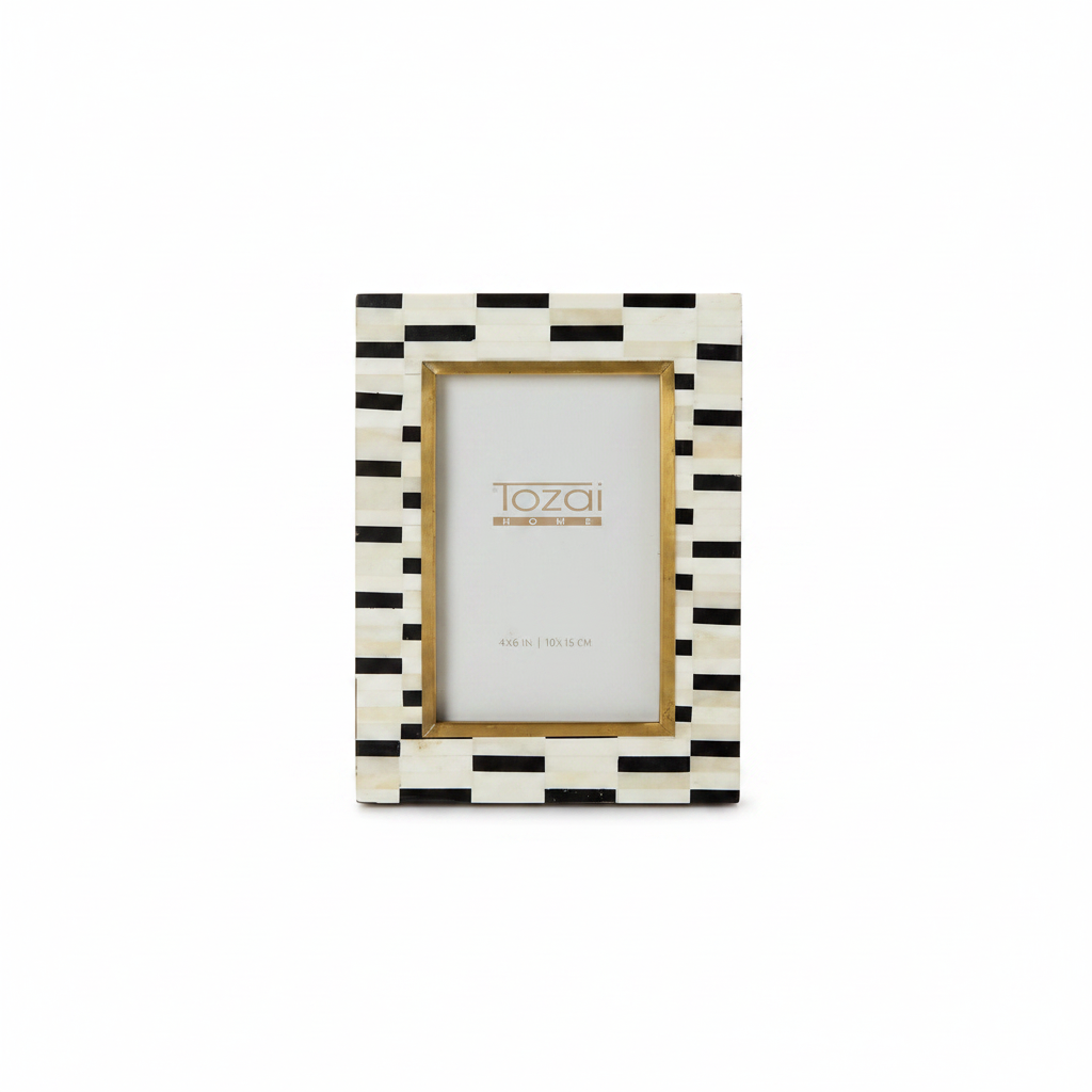 Black and white striped photo frame with gold accents on a white background