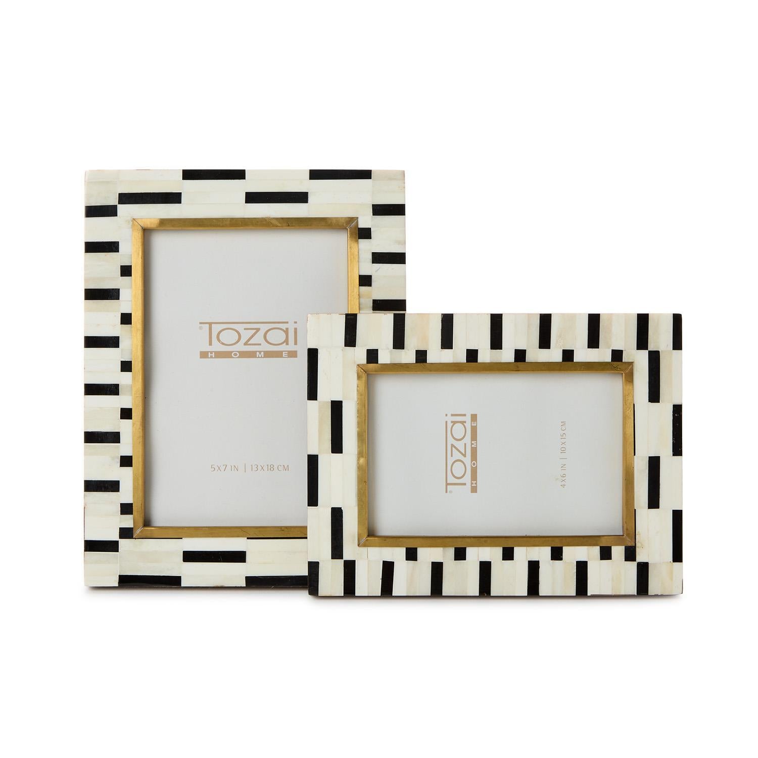 Two photo frames with black and white striped design on a white background