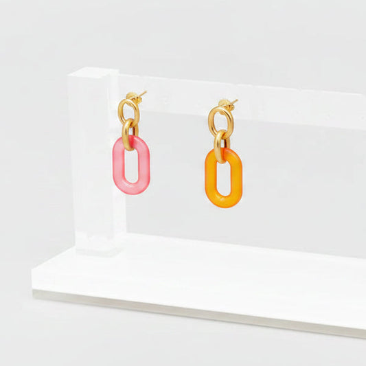 Zenzii Resin Oval Link Drop Earrings in pink and orange on a display