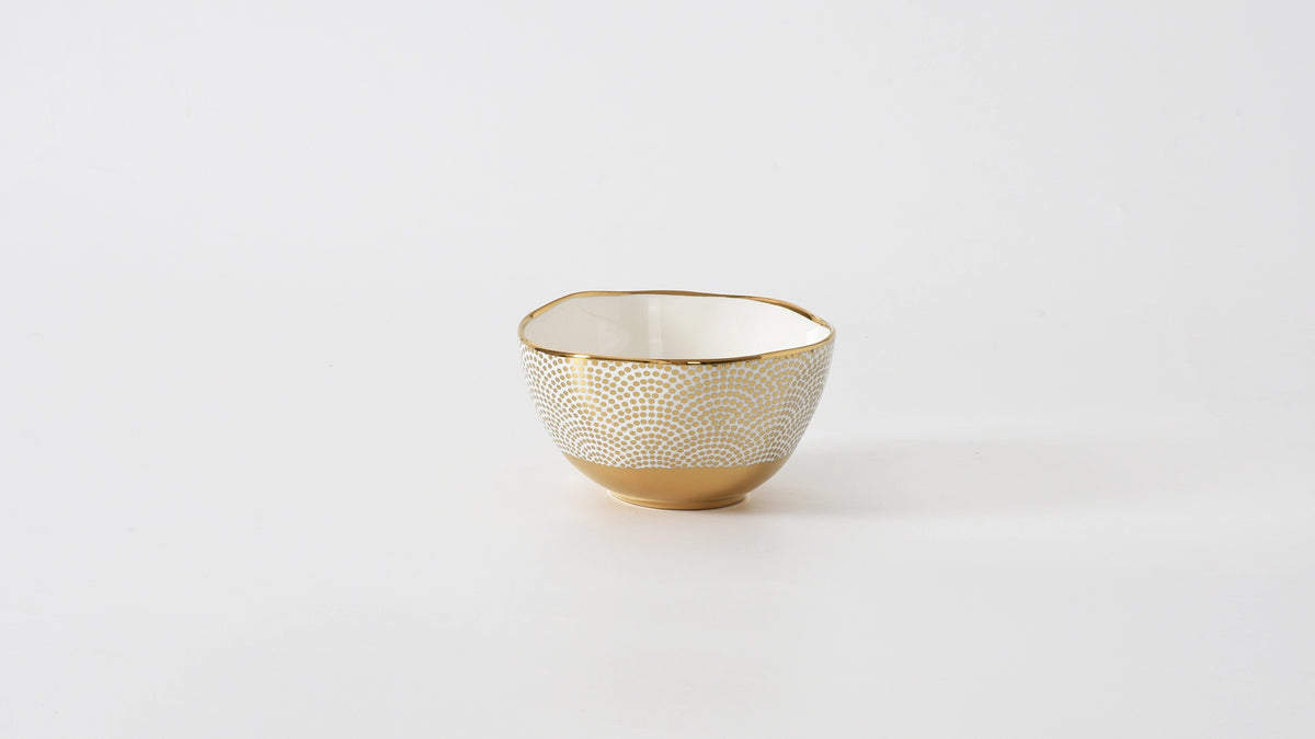 Small decorative bowl with gold pattern on a white background