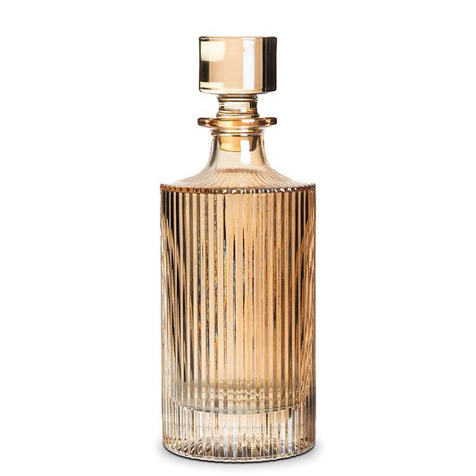 a glass decanter in an amber color with vertical ribbed lines