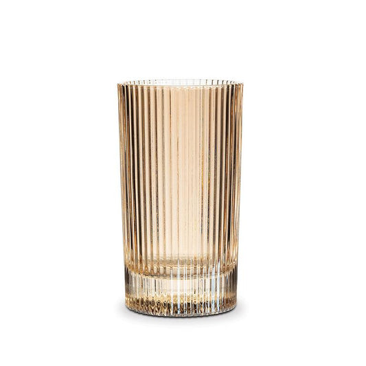 Clear glass amber colored highball glass with ribbed design on a white background