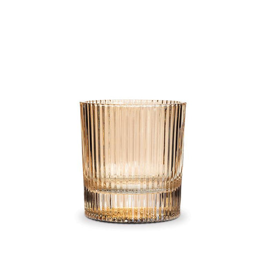 A single amber-tinted glass tumbler with a vertical ribbed pattern, shown on a clean white background.