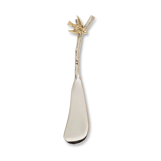 Decorative spreader with a handle with a brass bird on a branch 
