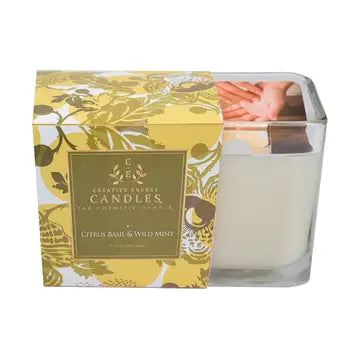 Citris basil and wild mint medium size lotion Candle with floral packaging on a white background