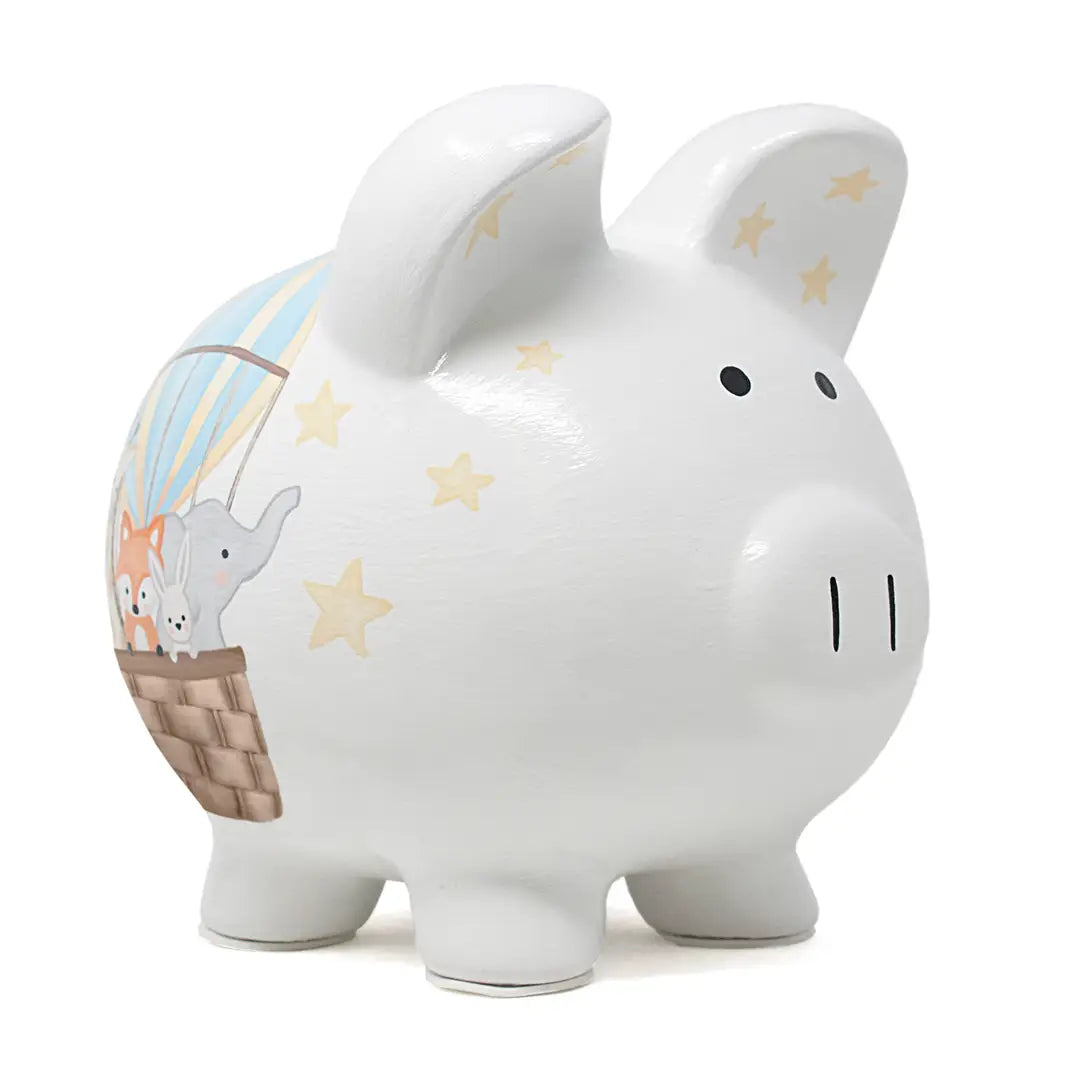 White ceramic piggy band with a hot air balloon with animals on one side and a moon and stars on the opposite