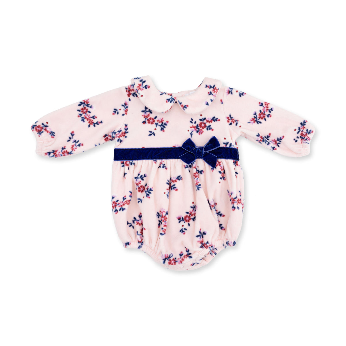 A baby long-sleeve romper in light pink velour with a navy and burgundy floral print, featuring a navy-blue velvet bow belt at the waist.