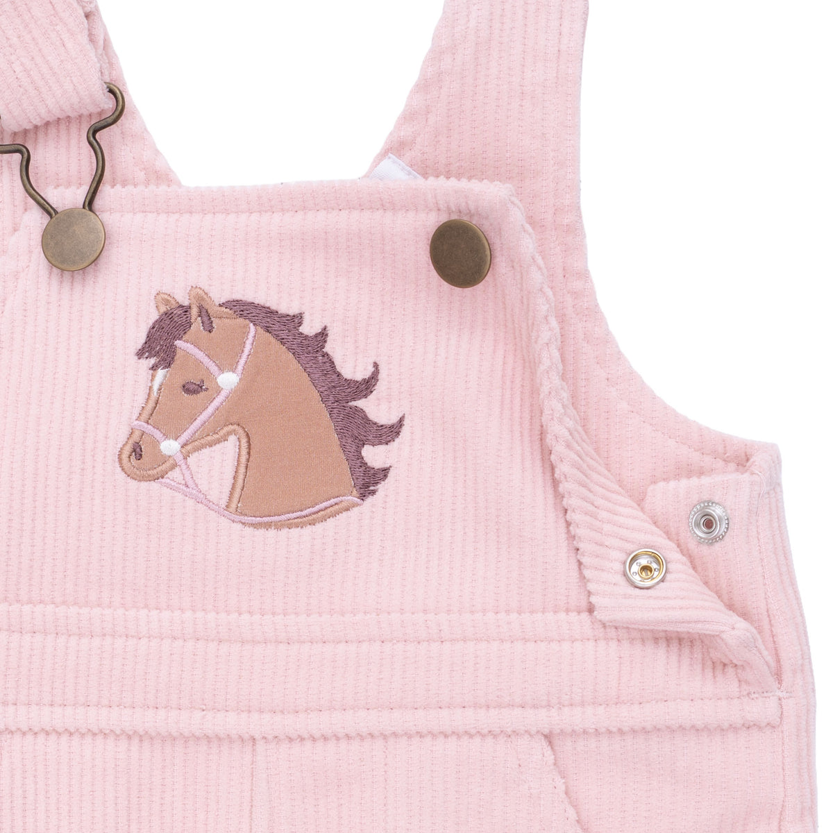 Pink corduroy overalls with horse applique on a white background