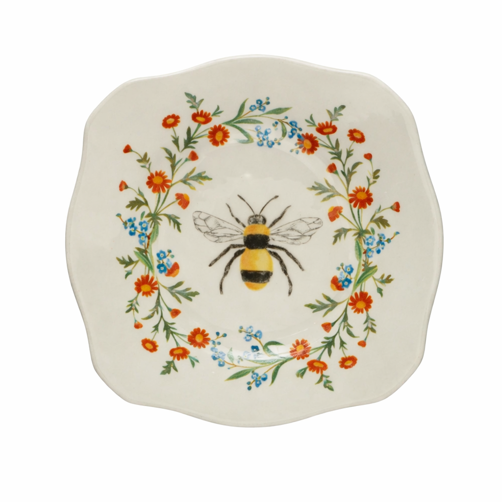 stoneware plate featuring a bee in a ring of flowers