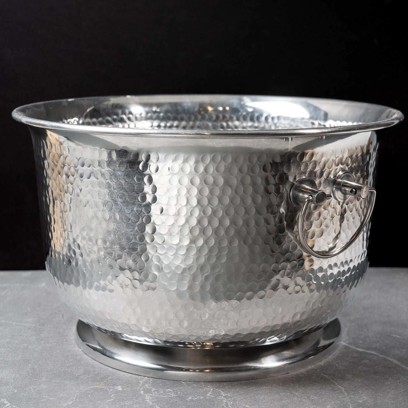 Silver hammered metal beverage tub with handles.