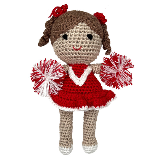 crocheted bamboo cheerleader rattle in a red and white uniform with pom-poms and red hair bows