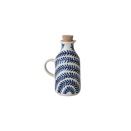 stoneware oil cruet with a blue leaf pattern